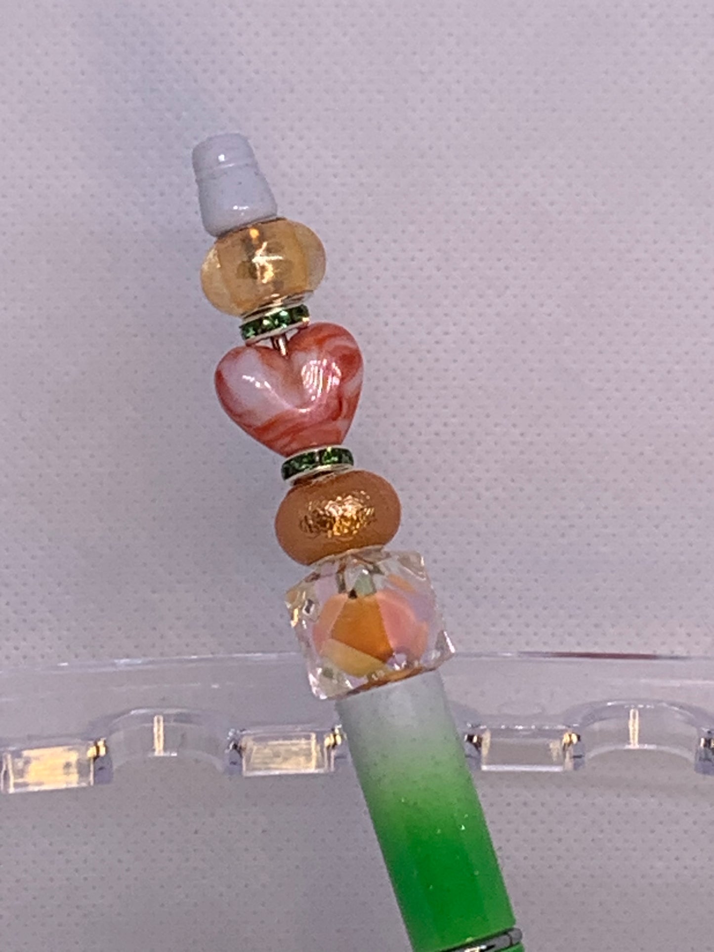 Shiny peach, orange beads with fancy Chunky red-orange heart