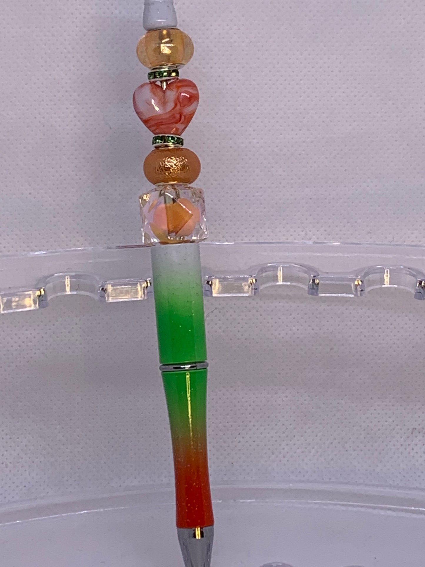 Shiny peach, orange beads with fancy Chunky red-orange heart