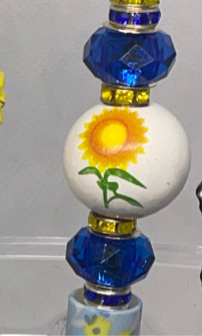 Sunflower-inspired beaded pencil with vibrant accents, perfect for cheerful writing.