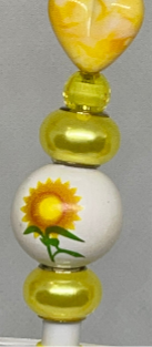 Sunflower-inspired beaded pencil with vibrant accents, perfect for cheerful writing.