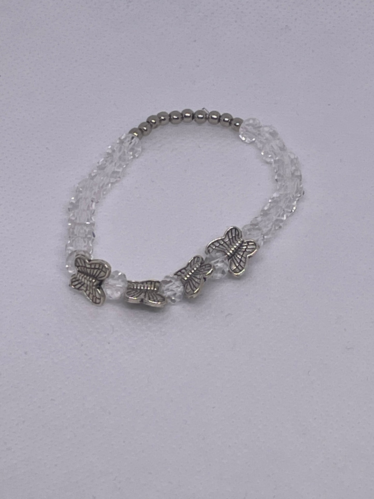 CLEAR ROUND 6mm with 4 SILVER BUTTERFLIES  with silver spacer beads 