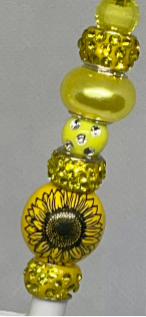 Sunflower-inspired beaded pencil with vibrant accents, perfect for cheerful writing.