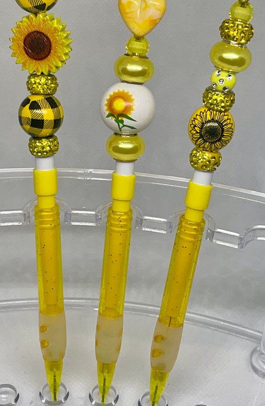 Sunflower-inspired beaded pencil with vibrant accents, perfect for cheerful writing.