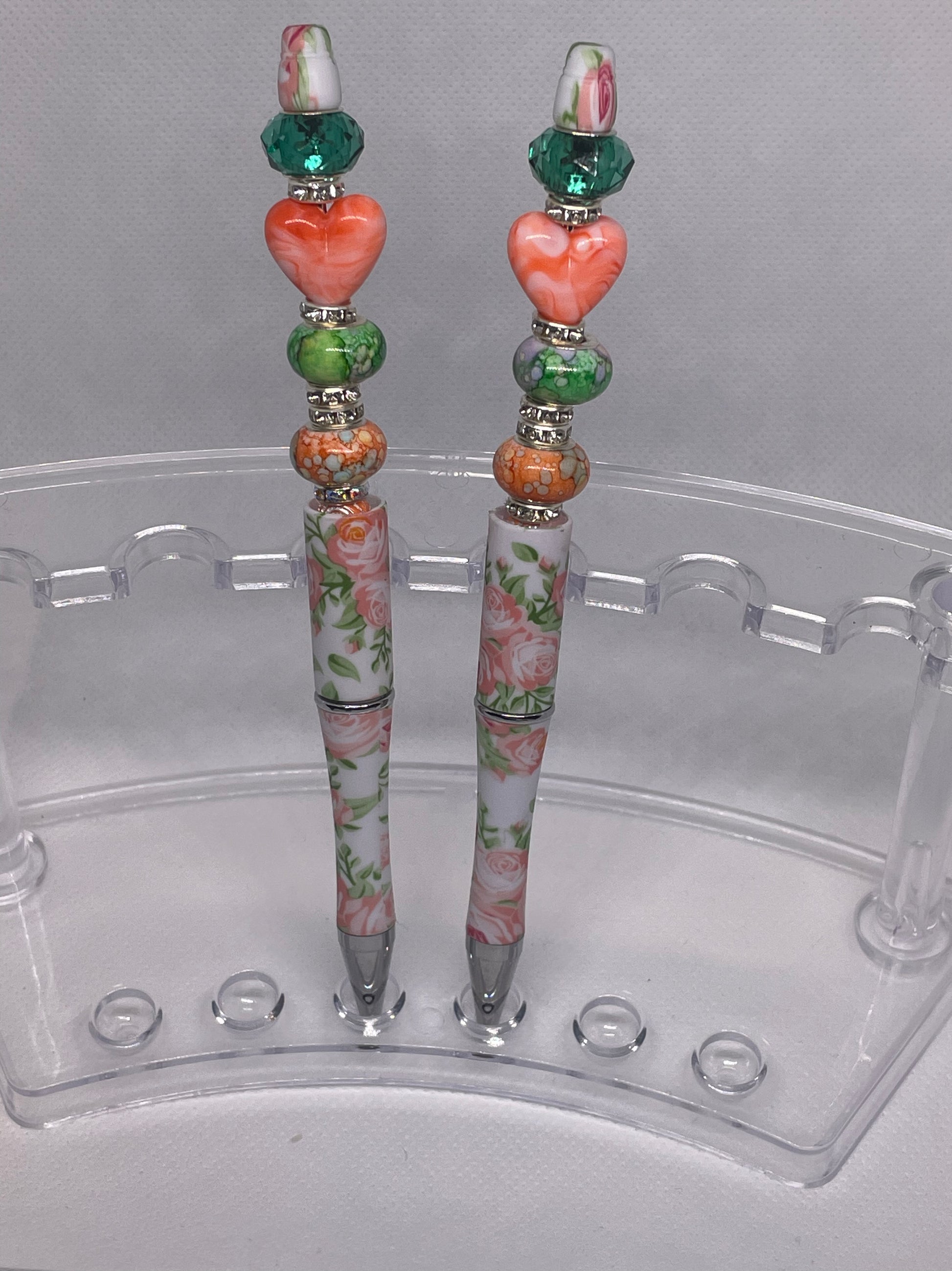 Romantic floral pen with pastel and green beads, perfect for adding charm to writing.