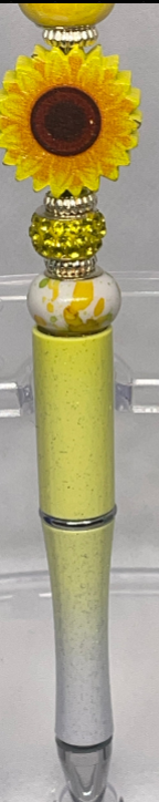 Handcrafted beadable pen with sunflower patterns and gold accents.